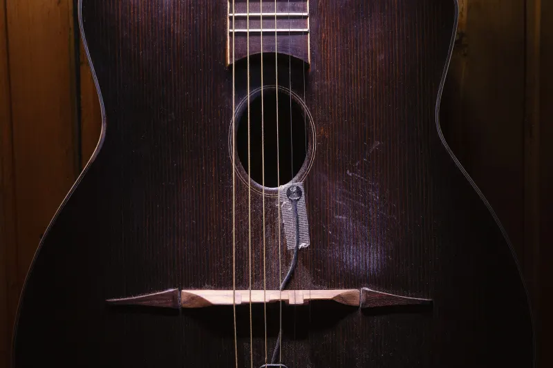 An acoustic guitar in low light