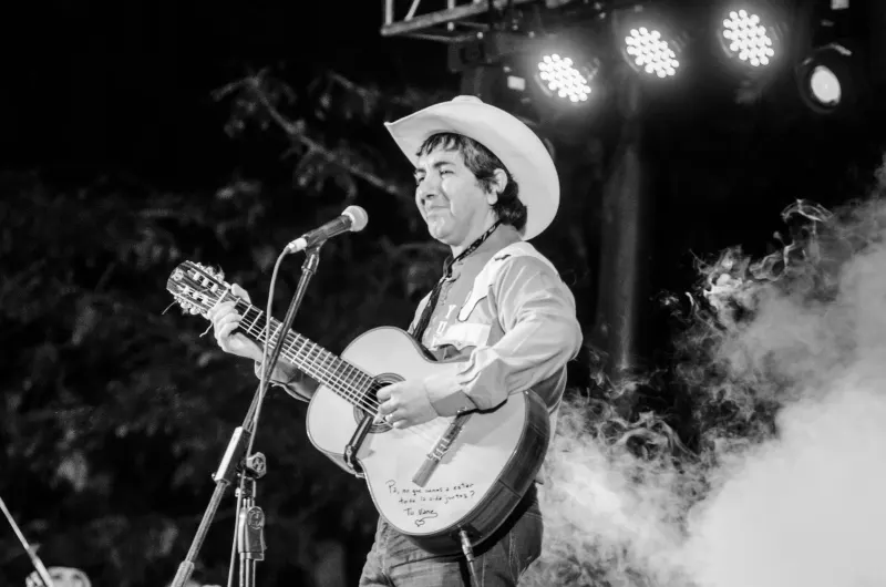 A singer in a cowboy hat performing at a country music festival